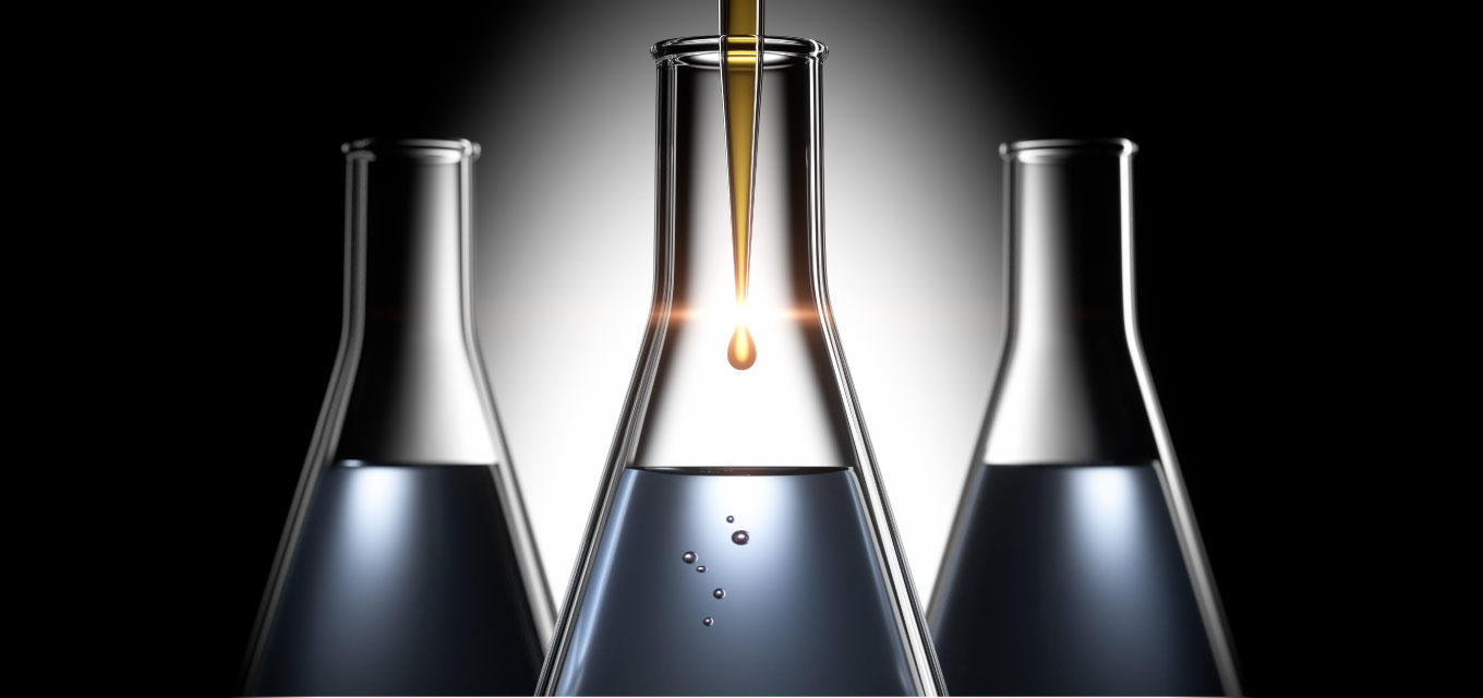 dark background with 3 beakers with liquid and the middle on closer and taller
